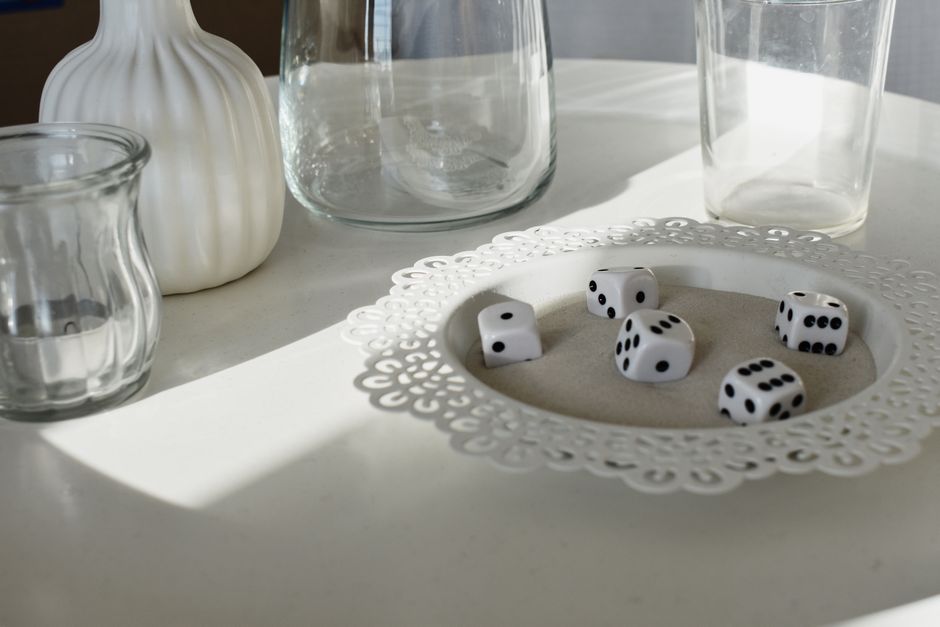 Dice and glassware arranged on a bright table